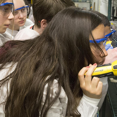 during your visit, students looking at science equipment